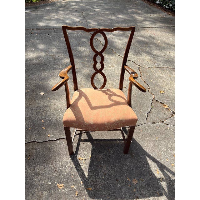 Stylish 18th Century English faded Mahogany Armchair with unusual splat and exaggerated arms design. Comfortable...