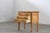 This oak side table, attributed to Danish designer Henning Kjærnulf, exemplifies the Brutalist aesthetic of the 1960s....