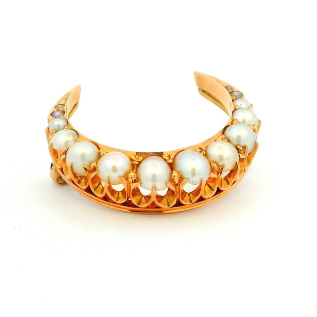 A romantic and highly collectible late Victorian crescent moon brooch, crafted in rich 15 karat yellow gold and set with...