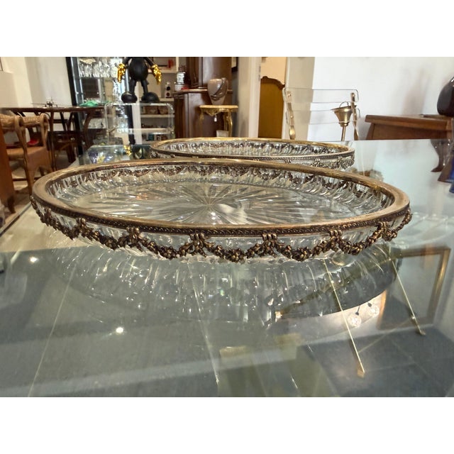 Pair of oval serving trays (or carafe/bottle coasters) in cut crystal, set in hand-chiseled 800/1000 sterling silver...