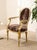 A fabulously dramatic French Louis XVI style armchair pairing an ornate giltwood frame with bold leopard-print upholstery....