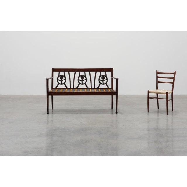 A refined Belgian Art Deco bench from around 1920, crafted in solid oak and shaped with the clean geometry and subtle...