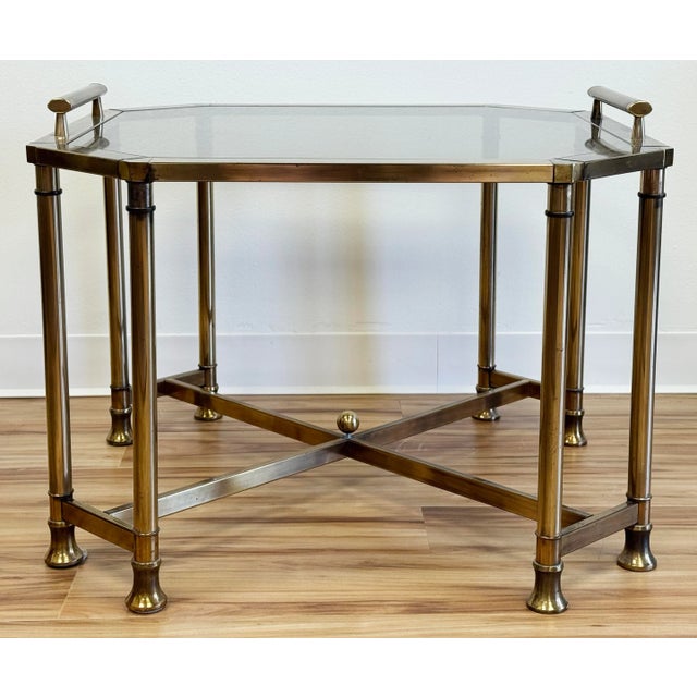 Substantial vintage brass and smoked glass side table. Features angular brass frame with tray look tabletop and eight legs...