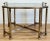 Substantial vintage brass and smoked glass side table. Features angular brass frame with tray look tabletop and eight legs...