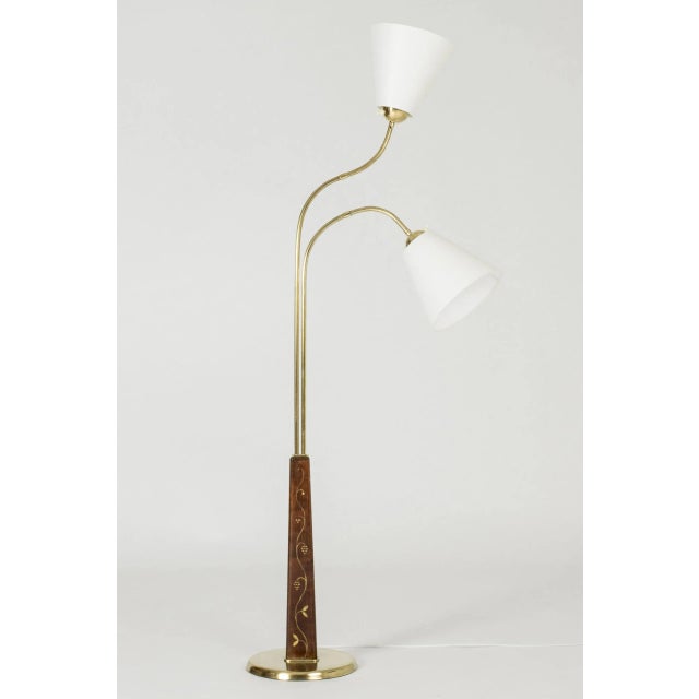 Elegant Swedish Modern floor lamp by Tor Wolfenstein, made from brass with two lamp shades. Tapering wooden base with...