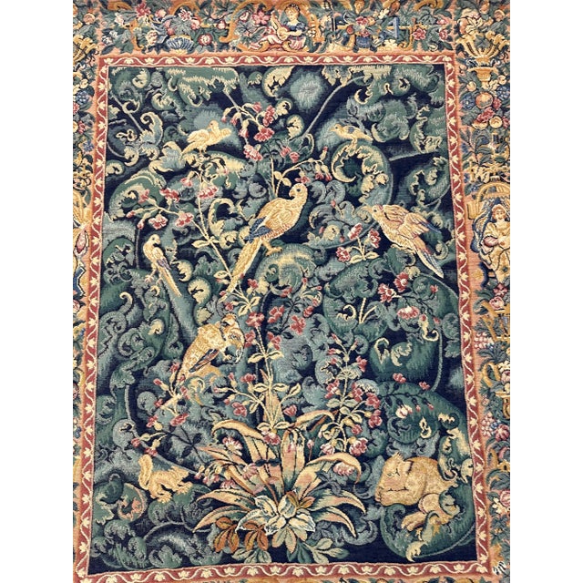 Wonderful hanging wall tapestry of birds and small animals in a lush forest scene surrounded by a border of woven old...