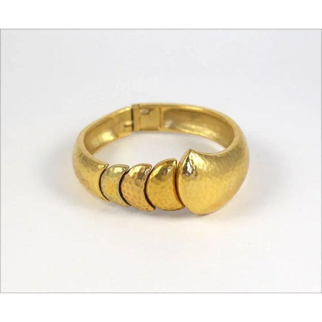 This is part of Chairish’s Costume Jewelry assortment. Hammered finish goldtone clamp bangle.