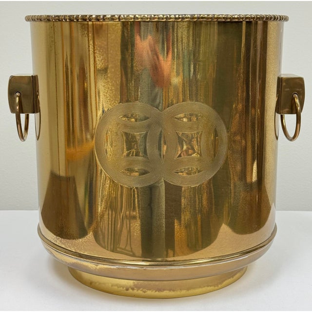 Vintage oversized Chinoiserie style brass planter with Asian etched symbols and prominent ring handles. Natural vintage...