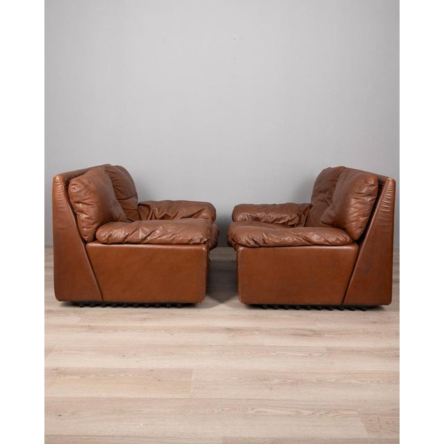Pair of brown leather armchairs, Bonheur model, design Titiana Ammannati & Giampiero Vitelli for Brunati, 1970s. This...