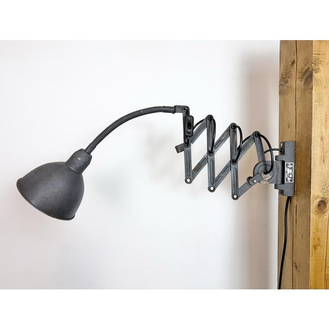 This vintage industrial adjustable gooseneck grey scissor wall light was produced by Elektroinstala Dečín in former...
