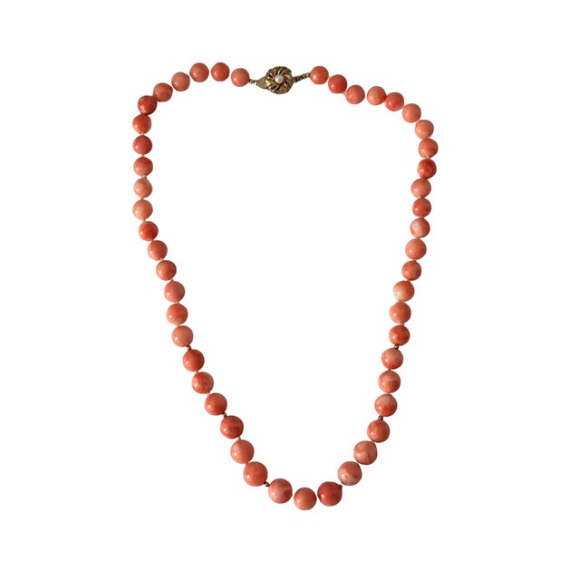 This vintage coral bead necklace features beautifully polished 14mm beads with rich color and a warm, natural glow....