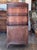 An English mahogany waterfall bookcase — three graduated open shelves stepping back in the classic waterfall shape, over a...