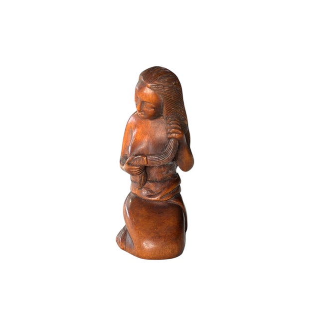 Finely carved wood netsuke figure of a seating young girl , artist's signature on the base, with holes drilled for...
