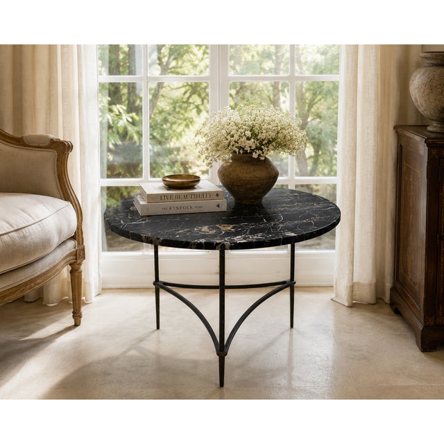 1970s Italian Portoro black marble cocktail or accent table with a sculptural patinated mixed-metal architectural tripod...