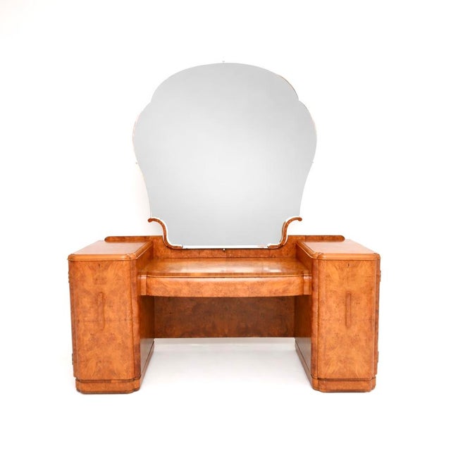 An absolutely stunning Art Deco burr walnut dressing table. This was made in England, it dates from the 1930’s. It is...