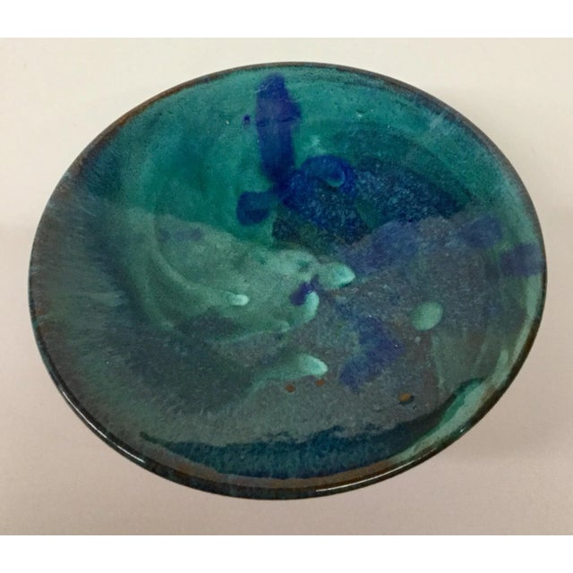 Gorgeous turquoise swirl design hand painted artisan clay bowl. These pieces are unique and one of a kind. Rich colors are...