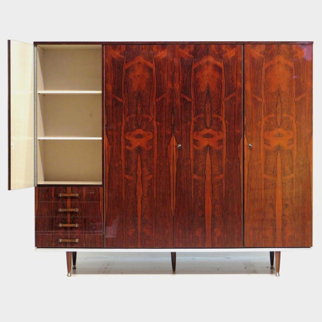 Vintage mid century modern wardrobe from the 1960s with four doors, four drawers, and a very unique rosewood woodgrain....