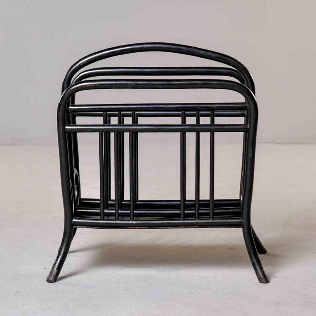 A bentwood magazine rack by Thonet, Vienna, circa 1900–1910. Steam-bent beechwood in an ebonized finish with...
