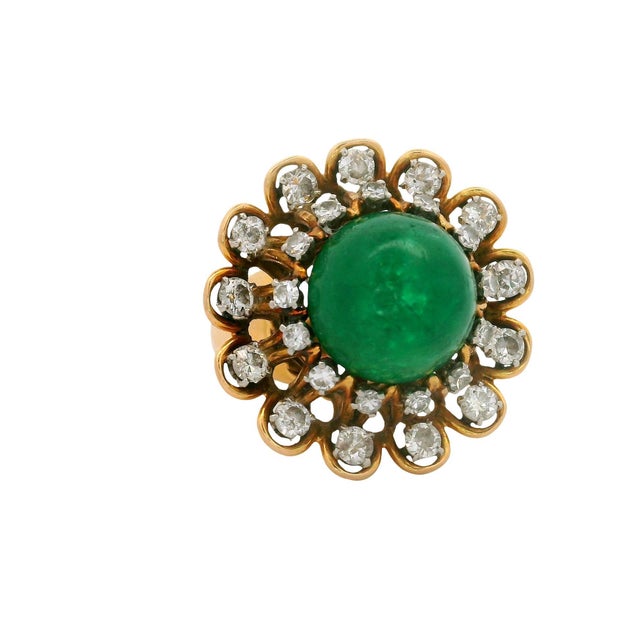 A captivating cocktail ring featuring approximately 6.00-carat cabochon emerald. The emerald, with its rich green hue, is...