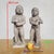 Pair of winged candle-bearing angels, carved from marble; they are depicted standing in a reverent pose, as they were...