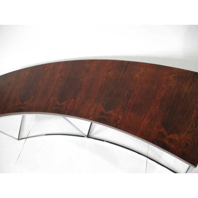An exceptionally stunning book matched Brazilian rosewood curved sofa table with chromed boxed tubed base. Designed by...
