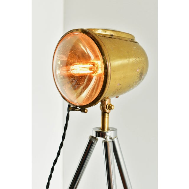 An unusual spotlight that was used in cars in 1920s made into a desk lamp with a tripod from the 70s. It is signed SideRay...