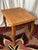 This vintage solid oak end table features a classic Late 20th-Century Colonial Revival silhouette with elegant Queen Anne-...