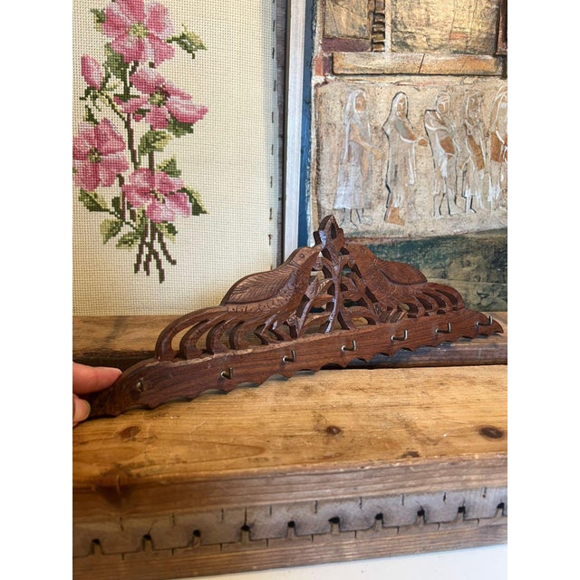 This rustic vintage wall decor has 7 hooks and is adorned with carved bird motifs. This piece has nice patina and...