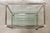 Elegant 1970s Hollywood Regency-style serving cart (or multi-purpose shelf), featuring a refined metal frame with a...