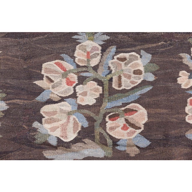 A remarkable example of Eastern European textile artistry, this Antique Bessarabian rug masterfully blends bold color...