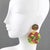 These stunning Lucite clip-on earrings feature a large disk-shaped dangling design with dimensional carving and multicolor...