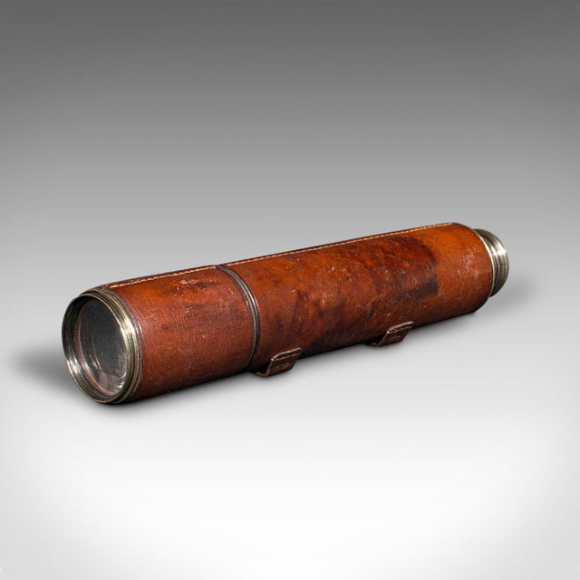 This is an antique 3 draw telescope. An English, brass and leather dressed refractor by Newton & Co, dating to the...