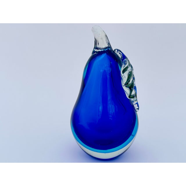 Measuring nearly 8 inches tall, this oversized glass pear could function well as a bookend - but would look equally...