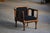 A beautiful Danish Art Nouveau armchair, crafted in stained birch wood and characterized by its strong architectural...