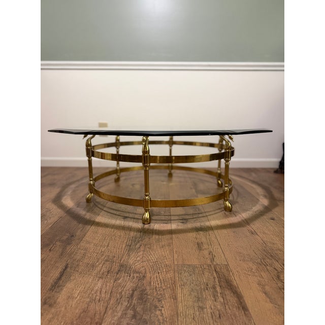 Lebarge glass octogon coffee table with brass swan head and hoof feet base. There is no label on the table. Glass has...