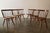 A set of 6 straight back chairs attributed to George Nakashima Studios c. 1960s. Hand carved spindles, sculpted seat,...