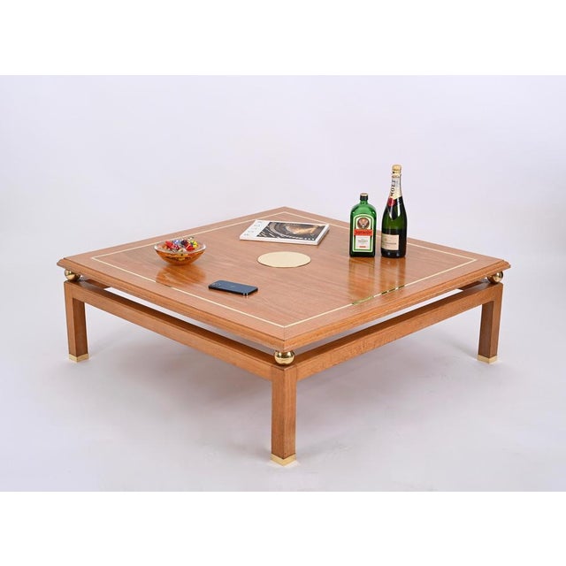 Gorgeous squared coffee table in oak wood and brass signed by Tommaso Barbi and produced in the 1970s in Italy. This...