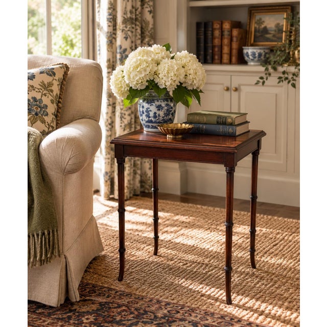 A particularly useful mid-20th-century mahogany side table with slender faux-bamboo legs and a restrained Regency-inspired...