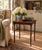 A particularly useful mid-20th-century mahogany side table with slender faux-bamboo legs and a restrained Regency-inspired...