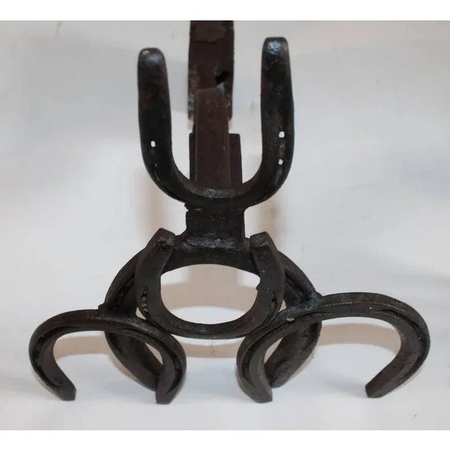 These folky handmade horse shoe andirons are in good condition and are very sturdy and heavy. Wonderful western Folk Art.