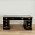 Handsome 19th century English desk handcrafted in mahogany with an ebonized finish, featuring a tooled green leather top...