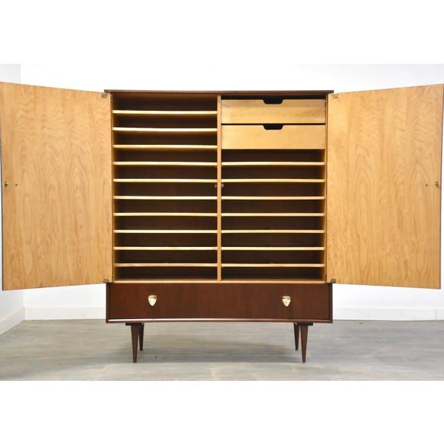 A mid century modern walnut armoire dresser with removable trays and brass hardware. Professionally refinished. 48” wide....