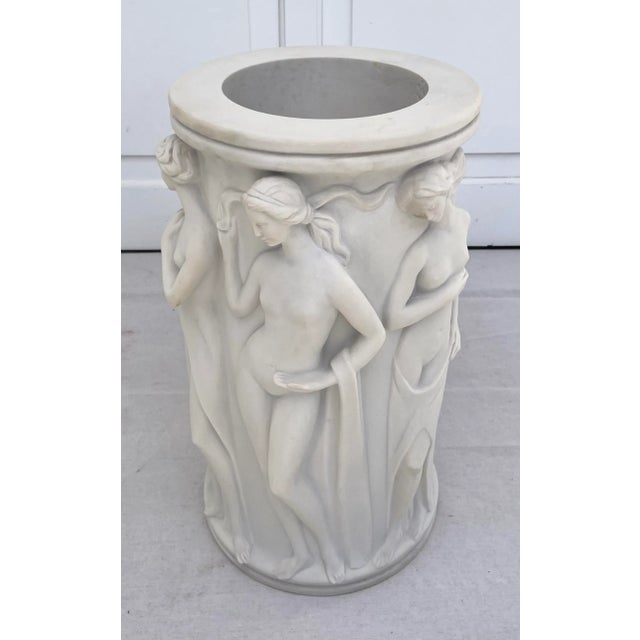 Here is an absolutely stunning umbrella stand that looks like it is carved from marble. The piece is actually a cast...