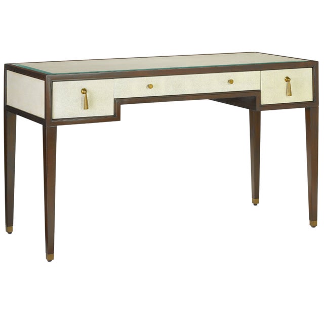The Evie Shagreen Desk, but Currey and Company, is made of mahogany in a dark walnut finish. The wood-framed panels and...
