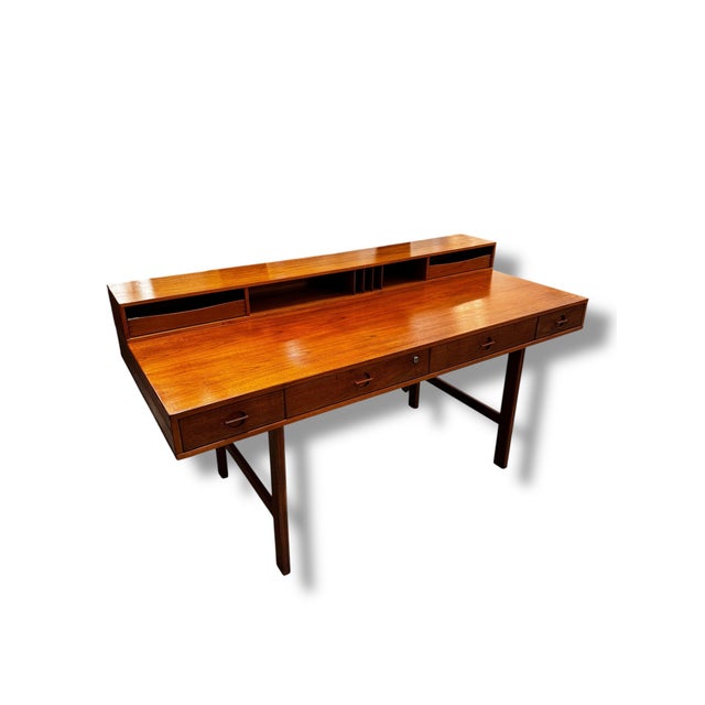 Beautiful Danish flip-top writing desk showcasing classic mid-century Scandinavian design and craftsmanship. Crafted in...