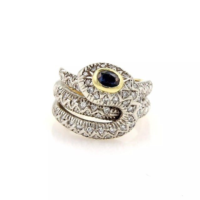 Material: 18k yellow and white gold Measurement: front: 21.5mm across x 16.8mm wide x 7.7mm high Diamond: 0.75ct Sapphire:...