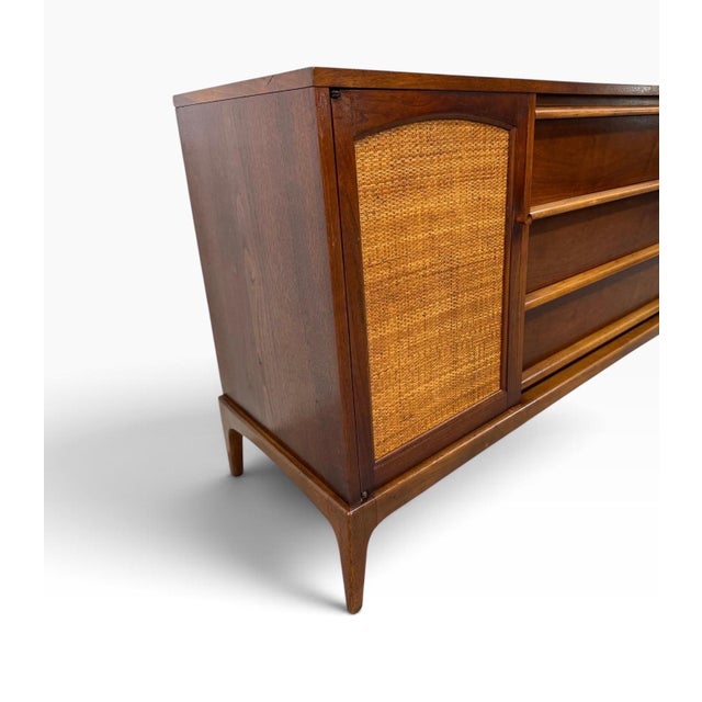 Showcase timeless American mid-century design with this Lane Rhythm Walnut Sideboard, dating to the 1960s. Partially...