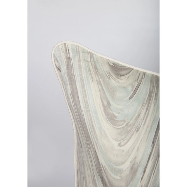 Pair of custom pillow covers made from a marble swirl pattern fabric in light gray, ivory, and blue. Solid coordinating...