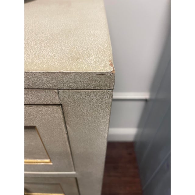 The Modern History Gustavian Dresser is finished in painted antique grey finish with gold leaf detailing that accents the...