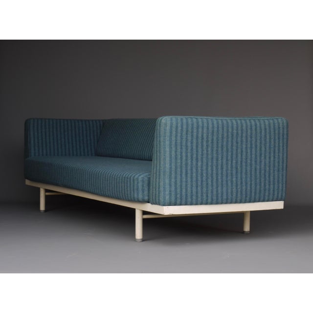 An unusual and interesting sofa with a drop down back rest that converts the sofa into a daybed with possible side shelf....